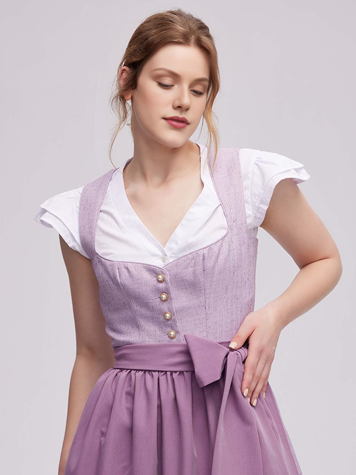 Elegantes lila Dirndl mit dezentem Ausschnitt bei einer festlichen Veranstaltung